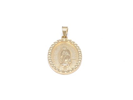 Medalla estilizada motivo guadalupano en oro amarillo 14 kilates. Sale